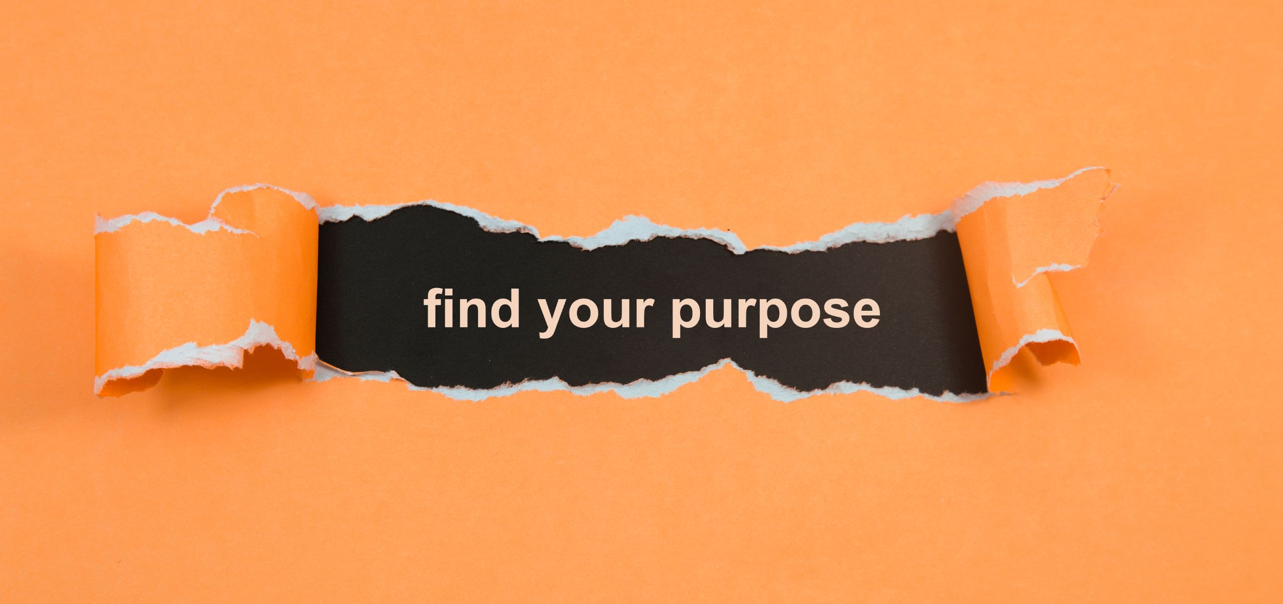 Orange paper torn in the middle revealing “Find Your Purpose,” emphasizing defining a brand’s core mission