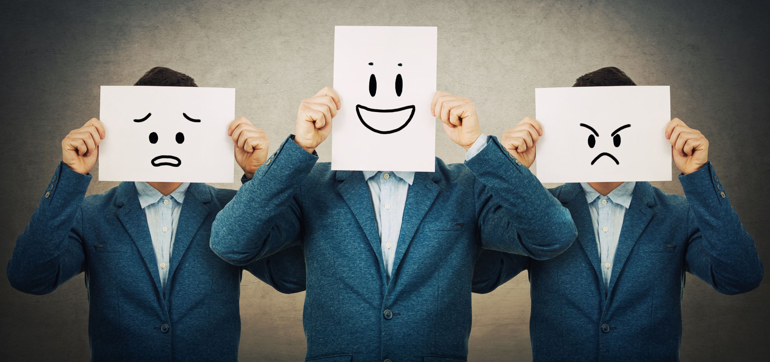 Three professionals holding papers with sad, happy, and angry faces