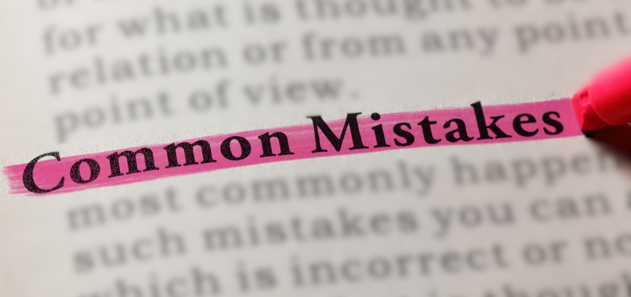 Open book page with “Common Mistakes” highlighted in pink, showing errors to avoid when writing emails
