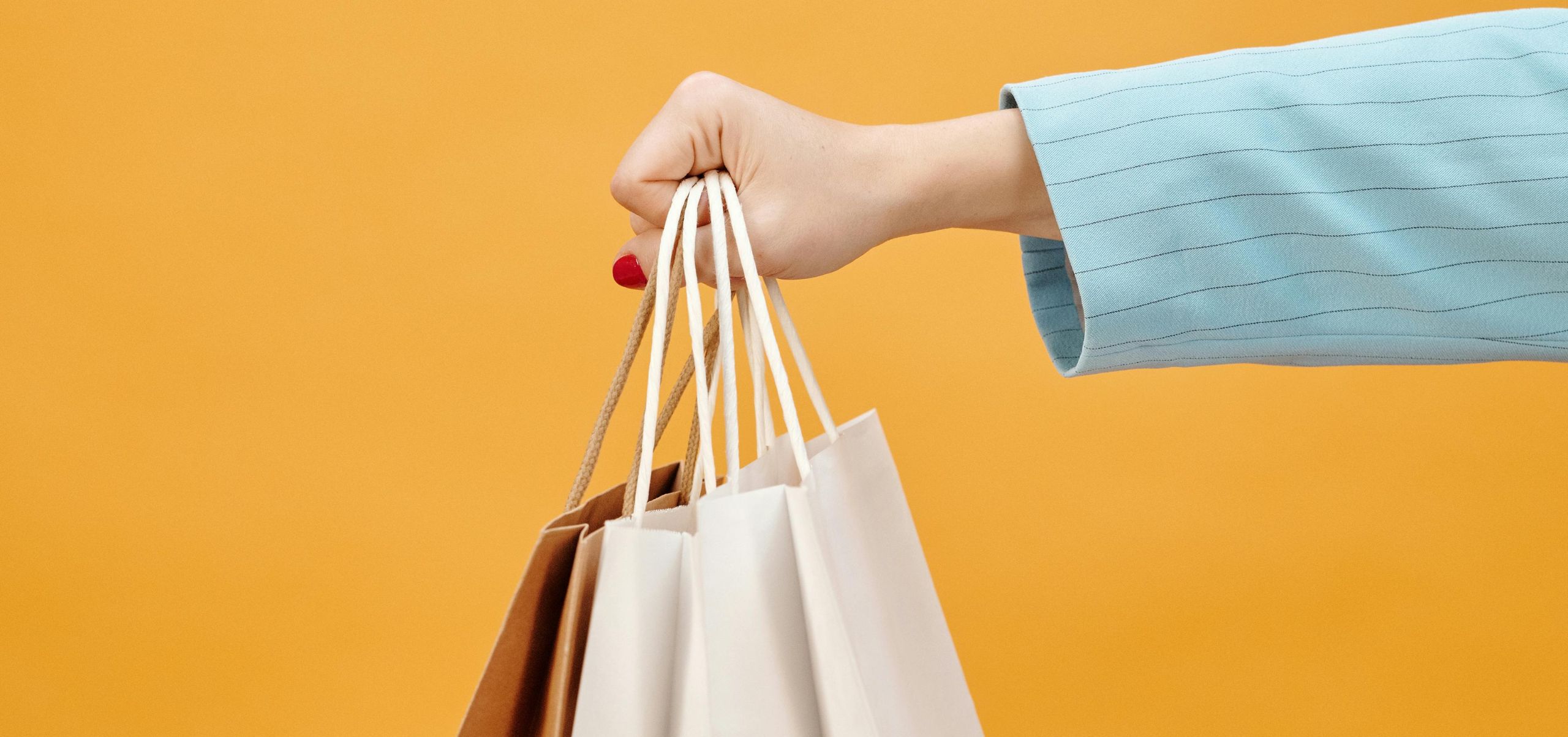 Woman handing out products in a paper bag