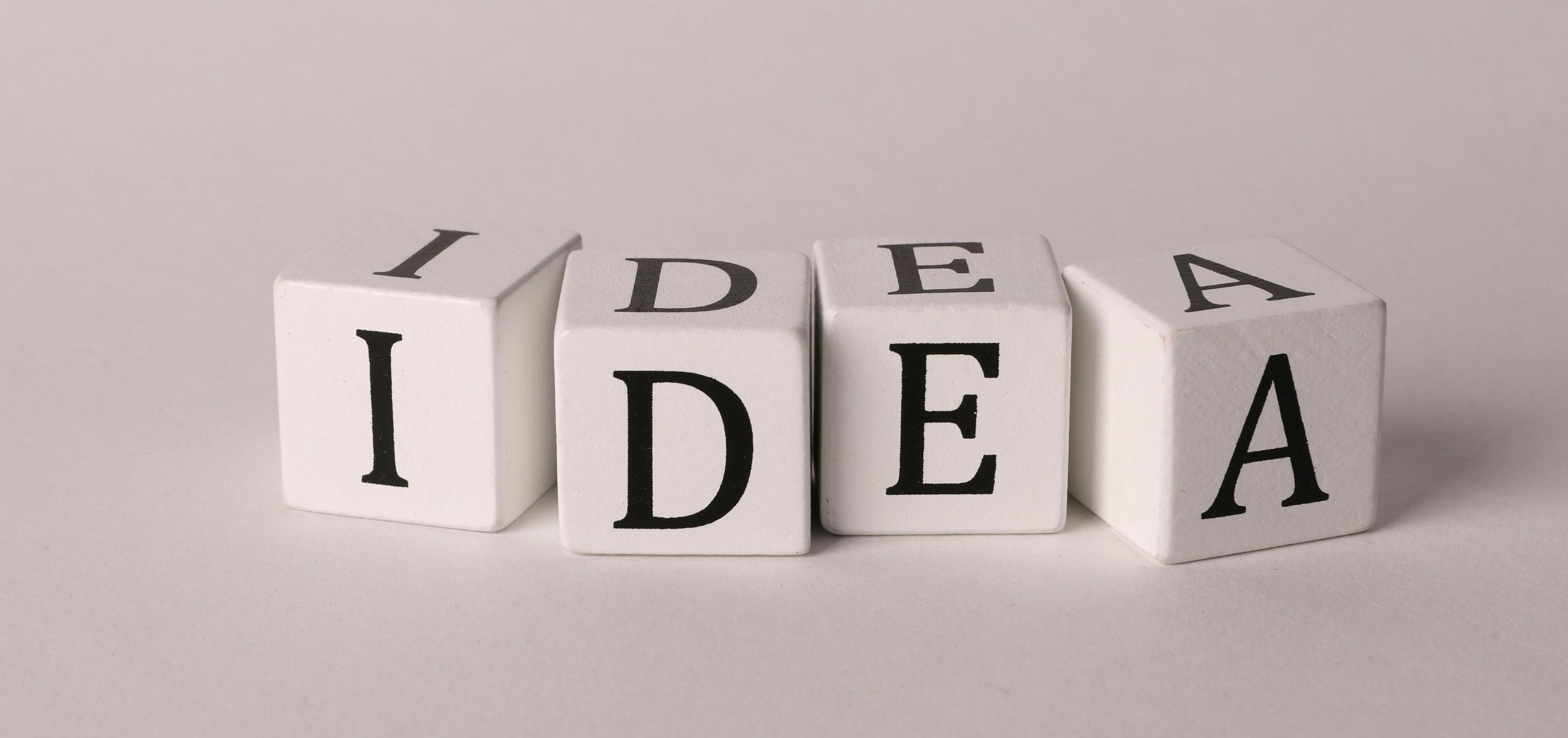 Blocks forming the word “Idea,” representing the starting point of a side business