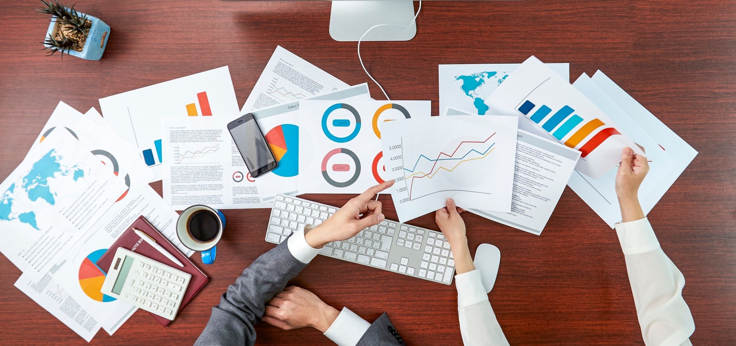 Papers spread across a table showing various metrics, representing performance measurement and business analytics