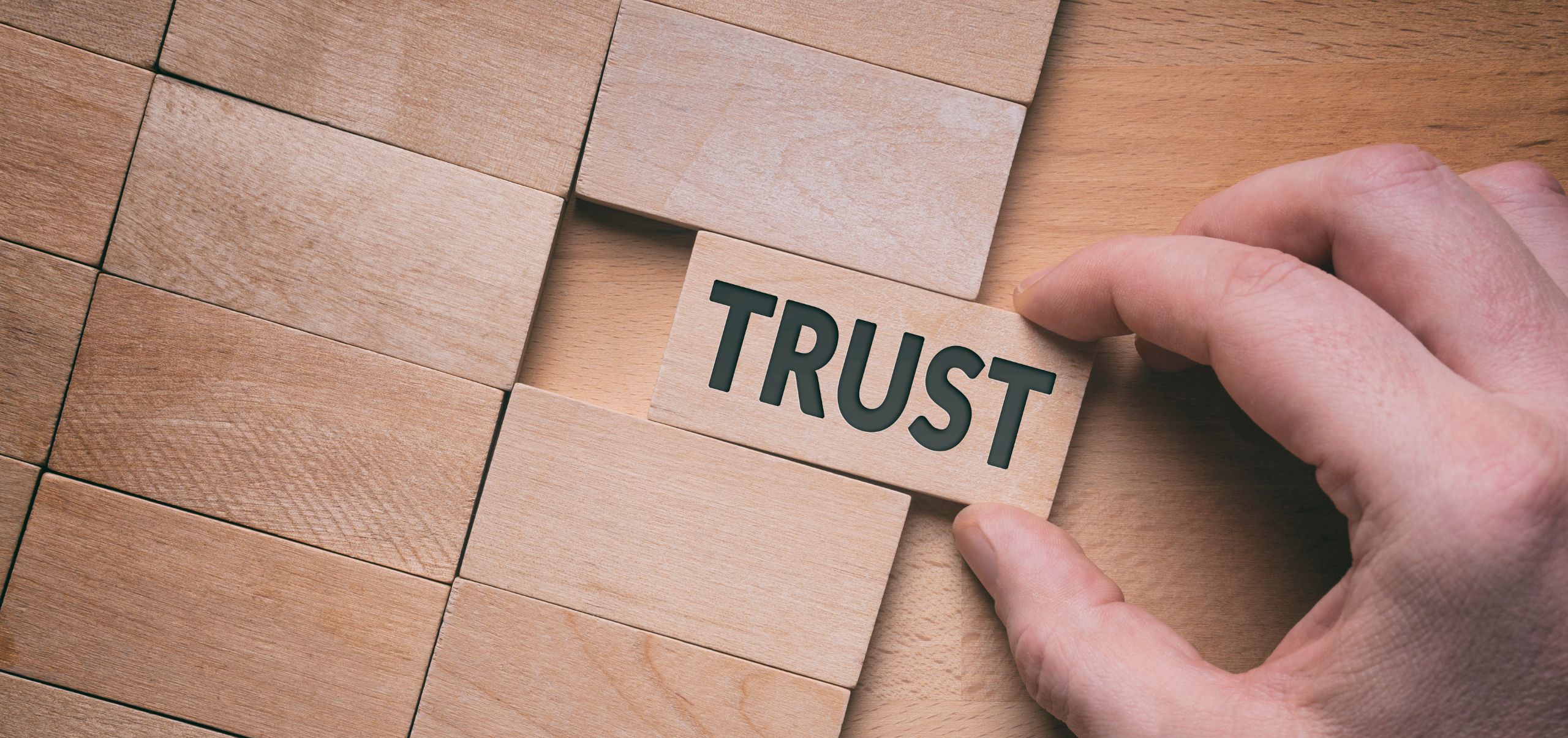 Block labeled trust placed among others to show the base of customer loyalty